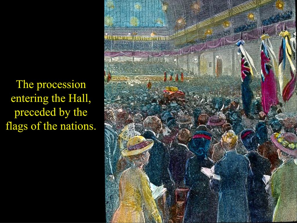 The procession entering the Hall, preceded by the flags of the nations.