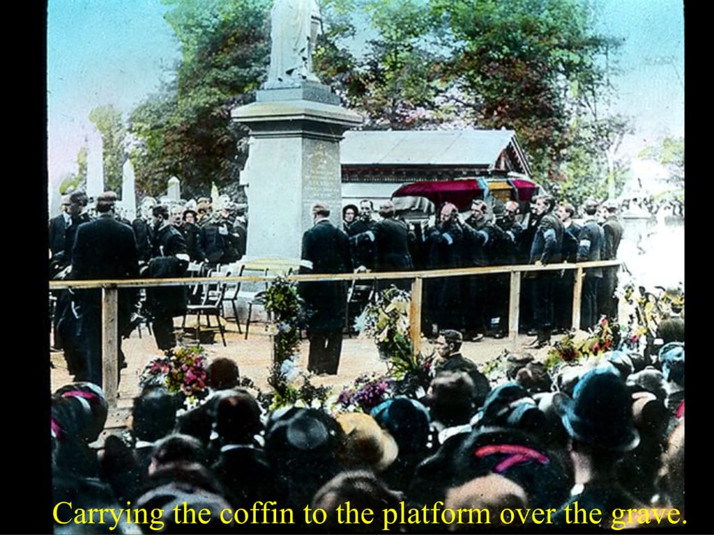 Carrying the coffin to the platform over the grave.